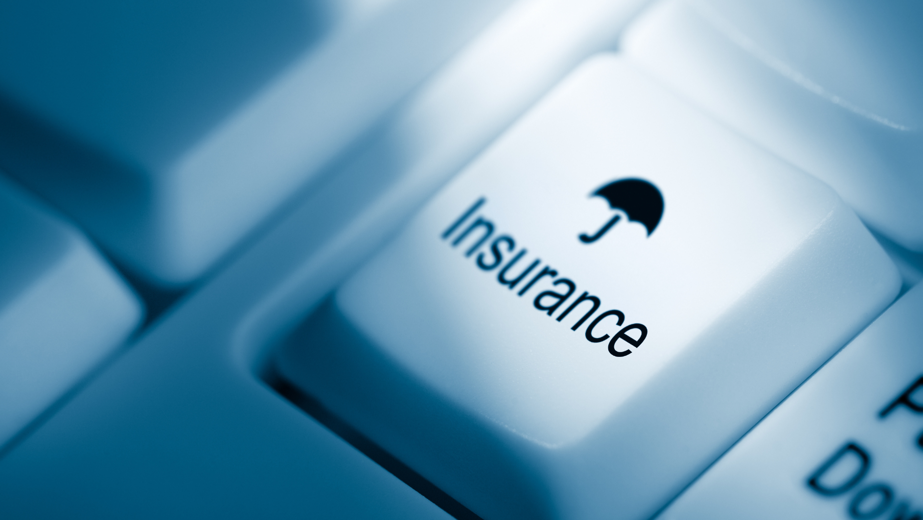 A close-up image of a computer keyboard with a white key labeled "Insurance" featuring an umbrella icon. The image, tinted with a blue hue, subtly emphasizes the relevance for Business Accountants navigating protection options.