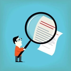 Cartoon of a man holding a large magnifying glass, examining a document with text and red lines, on a blue background. The magnifying glass makes part of the document appear larger.